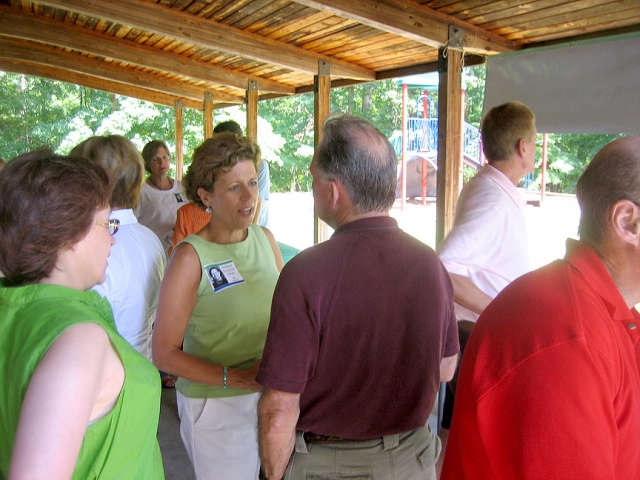 Debbie Stratton Mott talking with Mark Myers (Marks wife, Gloria in green on left)